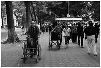 Elderly women pushing their wheelchairs while walking for exercise. Hanoi, Vietnam ( black and white)