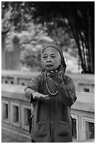 Elderly woman doing Tai Chi moves. Hanoi, Vietnam ( black and white)