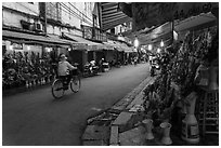 Street with flower sellers in early morning, old quarter. Hanoi, Vietnam (black and white)