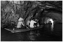 Boat rowed inside grotto passage, Trang An. Ninh Binh,  Vietnam ( black and white)
