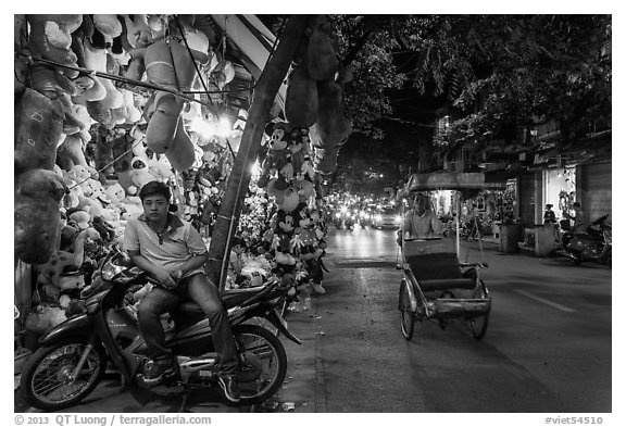 Street at night with motorcycle and cyclo, old quarter. Hanoi, Vietnam