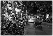 Street at night with motorcycle and cyclo, old quarter. Hanoi, Vietnam (black and white)