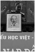 Officer hanging a picture of Ho Chi Minh, Hanoi Citadel. Hanoi, Vietnam ( black and white)