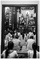Women worshipping in Phung Son Pagoda, district 11. Ho Chi Minh City, Vietnam ( black and white)