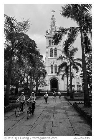 Students biking past Cho Quan Church, district 11. Ho Chi Minh City, Vietnam