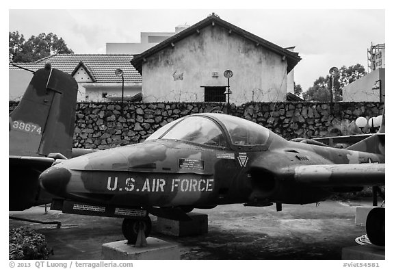 Warplane and wall with barbed wire, War Remnants Museum, district 3. Ho Chi Minh City, Vietnam (black and white)