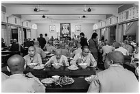 Monks and nuns having diner, An Quang Pagoda, district 10. Ho Chi Minh City, Vietnam ( black and white)