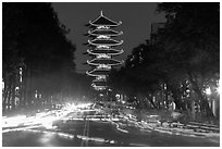 Traffic at night and Quoc Tu Pagoda, district 10. Ho Chi Minh City, Vietnam (black and white)