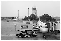 Airliner and control tower, Tan Son Nhat airport, Tan Binh district. Ho Chi Minh City, Vietnam ( black and white)