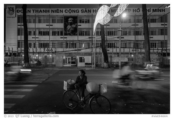 Vendor with bicycle at night. Ho Chi Minh City, Vietnam