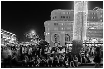 Revellers sitting on street, New Year eve. Ho Chi Minh City, Vietnam (black and white)