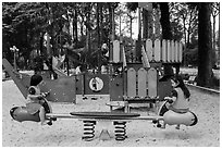 Girls with matching outfits on playground, Van Hoa Park. Ho Chi Minh City, Vietnam (black and white)