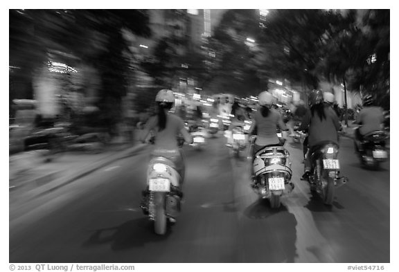 Blurry view from middle of street traffic at night. Ho Chi Minh City, Vietnam (black and white)