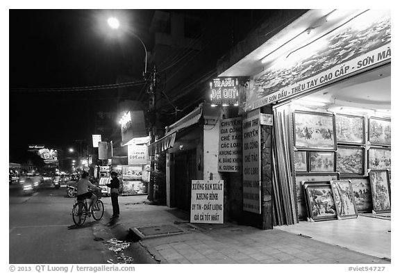 Stores selling pictures at night. Ho Chi Minh City, Vietnam (black and white)