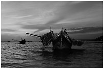 Man on fishing boat at sunset. Mui Ne, Vietnam ( black and white)