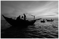 Fishermen on boats at sunset. Mui Ne, Vietnam ( black and white)