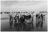 Women gather on beach to collect freshly caught fish. Mui Ne, Vietnam ( black and white)