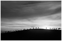 Tourists watching sunset from dune. Mui Ne, Vietnam ( black and white)