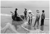 Fishermen, net, and coracle boat. Mui Ne, Vietnam ( black and white)