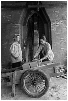 Workers loading bricks out of brick oven. Mekong Delta, Vietnam ( black and white)