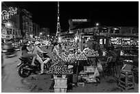 Street market and telecomunication tower at night. Tra Vinh, Vietnam (black and white)