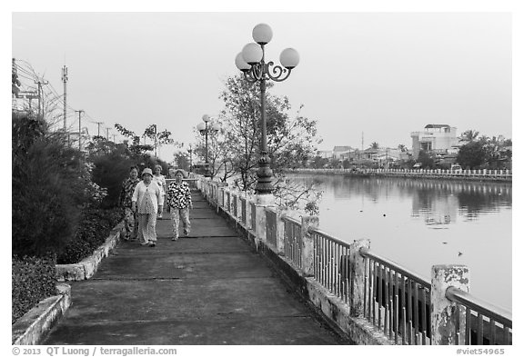 Elderly women strolling on riverfront. Tra Vinh, Vietnam (black and white)