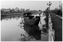 Woman in high heels walking out of barge. Tra Vinh, Vietnam ( black and white)