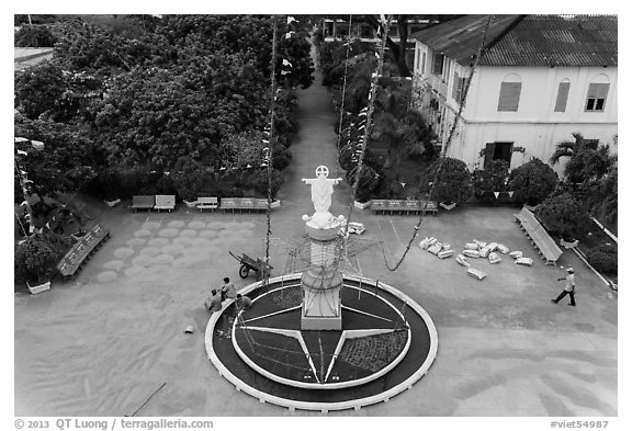 View of drying rice and statue from church tower. Tra Vinh, Vietnam (black and white)