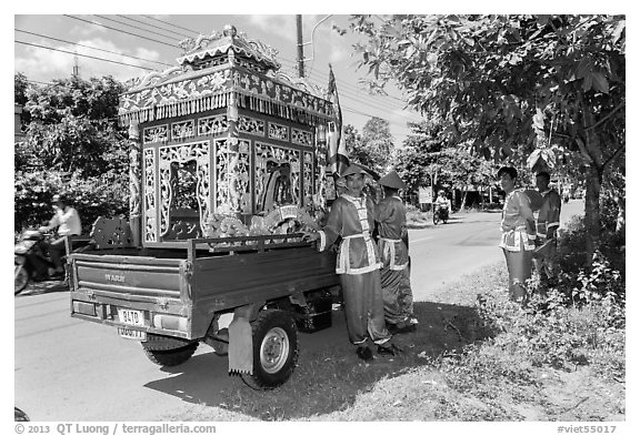 Funeral vehicle and attendants. Tra Vinh, Vietnam (black and white)