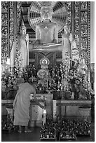 Monk lighting incense at  Ang Pagoda altar. Tra Vinh, Vietnam ( black and white)