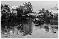 Barge and canal-side houses. Mekong Delta, Vietnam ( black and white)
