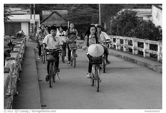 Children bike on way to school, Phung Diem. Can Tho, Vietnam (black and white)