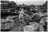 Fruit being sold from boat to boat, Phung Diem floating market. Can Tho, Vietnam (black and white)