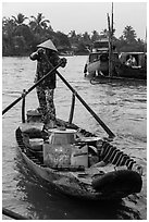 Woman paddles boat with pho noodles, Phung Diem. Can Tho, Vietnam ( black and white)