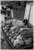 Woman paddles boat fully loaded with produce, Phung Diem. Can Tho, Vietnam (black and white)