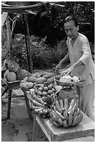 Woman selling fruit from roadside stand. Can Tho, Vietnam (black and white)