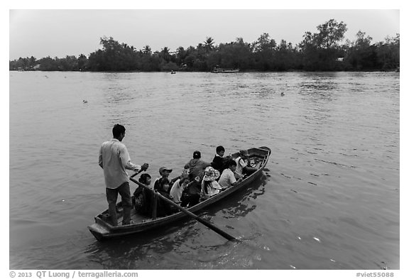 Schoolchildren crossing river on boat. Can Tho, Vietnam (black and white)