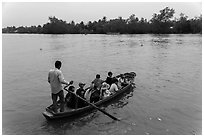 Schoolchildren crossing river on boat. Can Tho, Vietnam ( black and white)