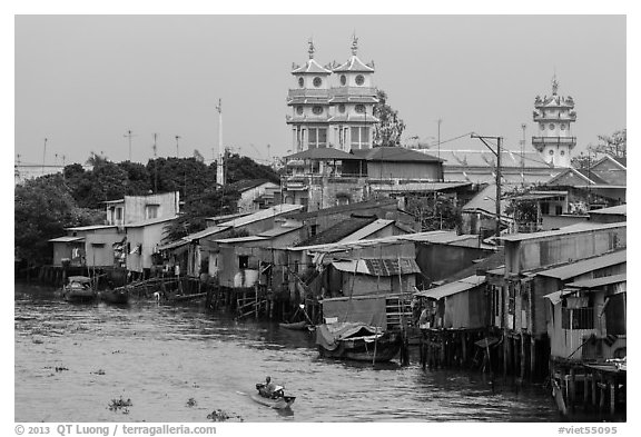 Riverside houses on stilts and Cao Dai temple. Mekong Delta, Vietnam (black and white)