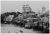 Riverside houses on stilts and Cao Dai temple. Mekong Delta, Vietnam ( black and white)