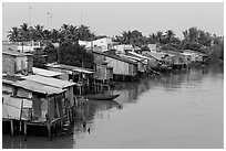 Riverside houses on stilts. Mekong Delta, Vietnam (black and white)