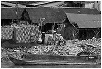 Workers loading bricks on boat. Sa Dec, Vietnam ( black and white)