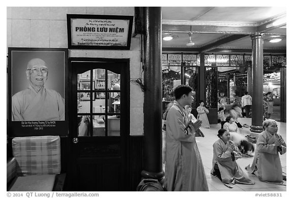 Women in prayer inside Quoc Tu pagoda. Ho Chi Minh City, Vietnam (black and white)