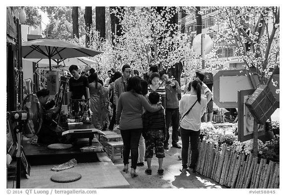 Sidewalk with Lunar New Year decorations and booths. Ho Chi Minh City, Vietnam (black and white)
