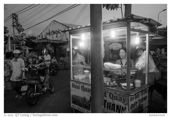 Food vendor at dusk, Con Dao Market, Con Son. Con Dao Islands, Vietnam (black and white)