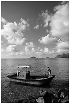 Fisherman lifting anchor from boat, Con Son. Con Dao Islands, Vietnam ( black and white)