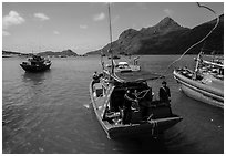 Sailor throws rope from boat, Ben Dam harbor. Con Dao Islands, Vietnam ( black and white)