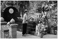 Woman offers incense at Vo Thi Sau grave. Con Dao Islands, Vietnam ( black and white)