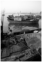Fisherman relax in a boat, Dong Hoi. Vietnam (black and white)