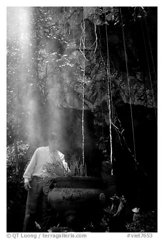 Urn and incense near the entrance of Phong Nha Cave. Vietnam (black and white)